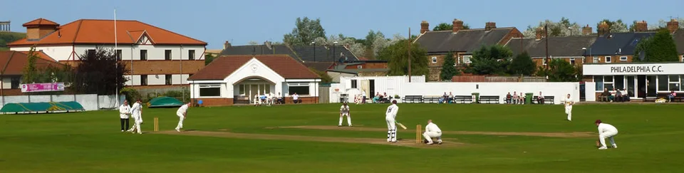 Cricket being played at Philadelphia’s Bunker Hill ground, with the clubhouse beyond